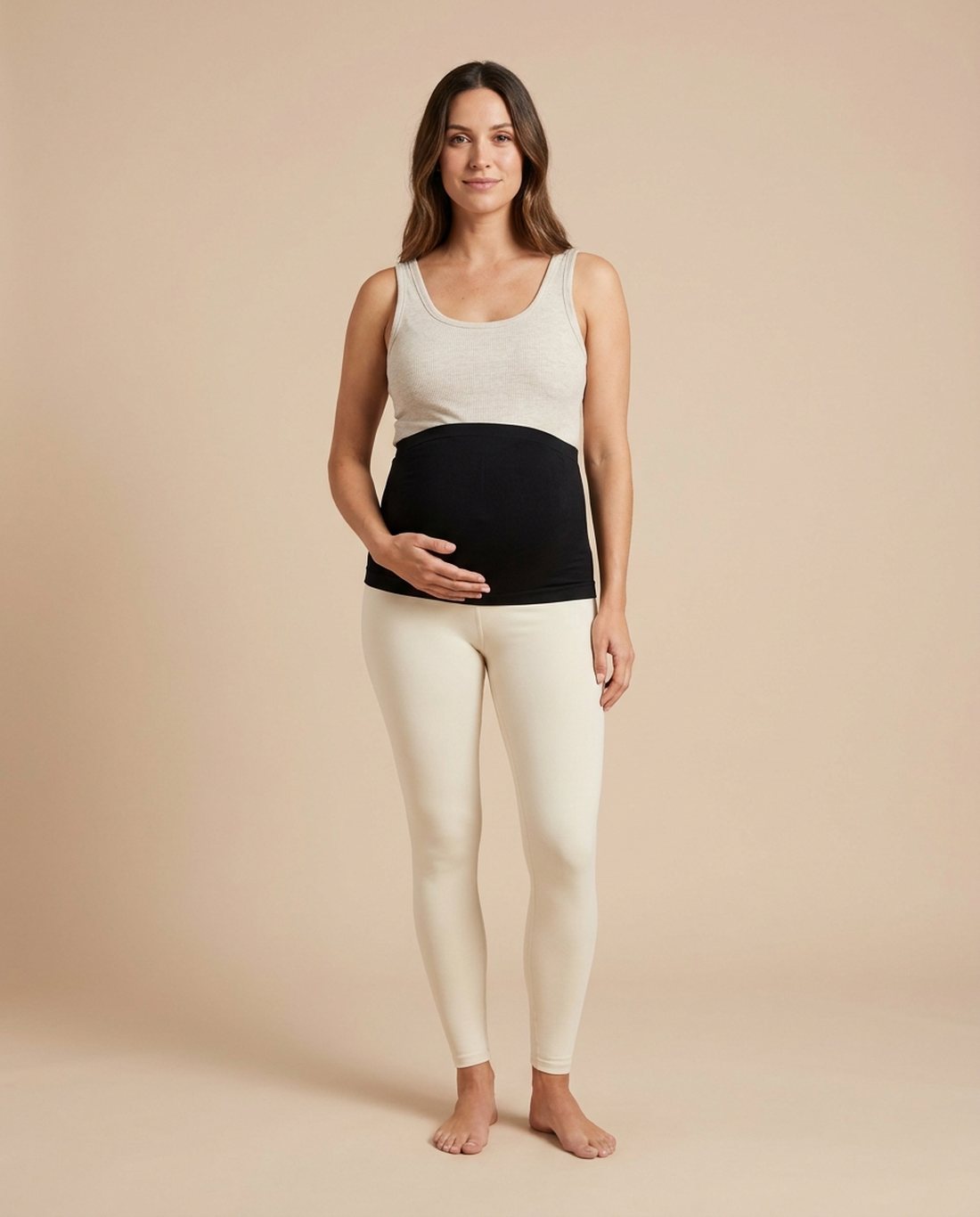 Maternity belly band worn over leggings, studio portrait