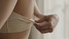 Warm morning light on soft cream maternity fabric